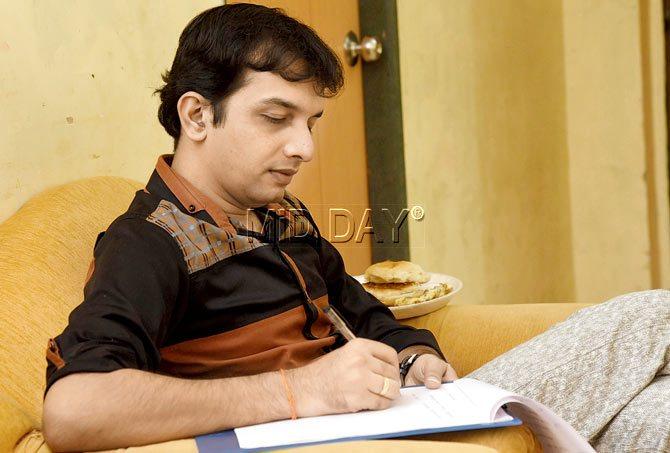 Dr Nilesh Sable works on the script during rehearsal