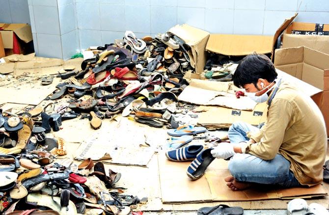 At the GreenSole factory at Mahape, a worker sorts through a pile of old footwear