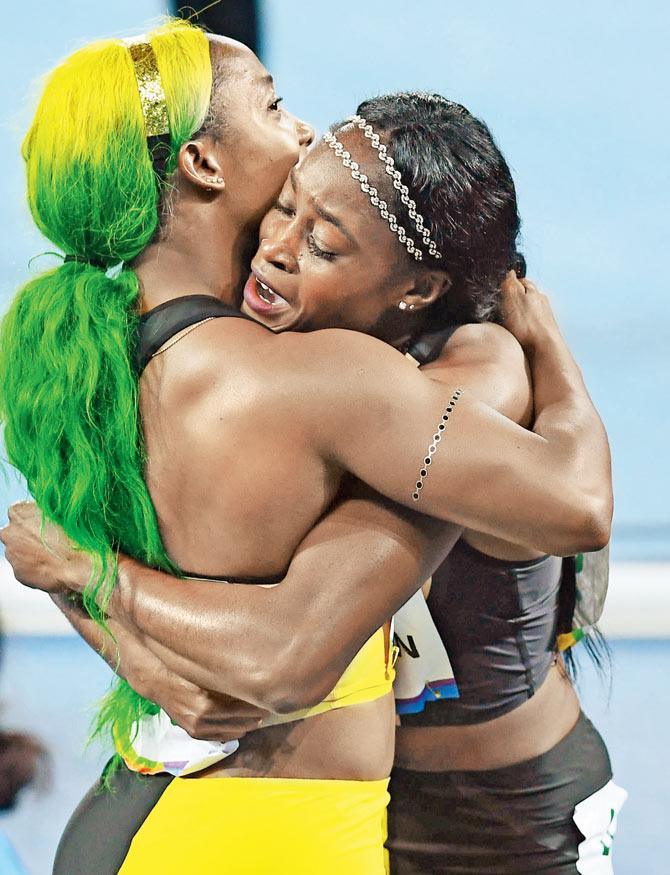 Jamaican Elaine Thompson (right) hugs  compatriot Shelly-Ann Fraser-Pryce after  the 100m final at Rio on Saturday. 