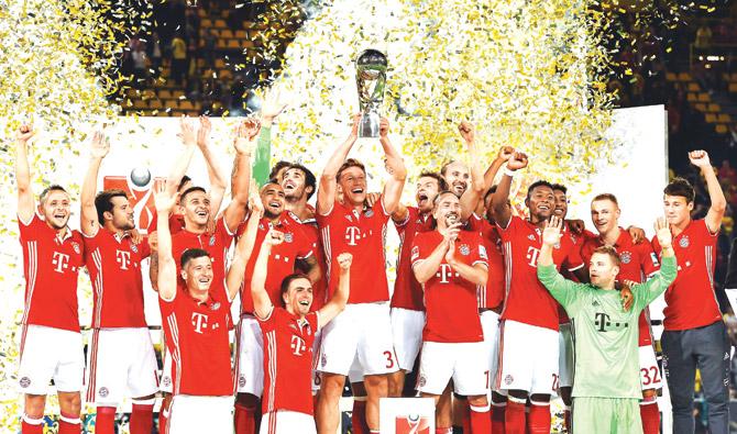 Bayern Munich players celebrate with the trophy after their 2-0 win vs Borussia Dortmund in the German Super Cup final on Sunday. Pic/AFP