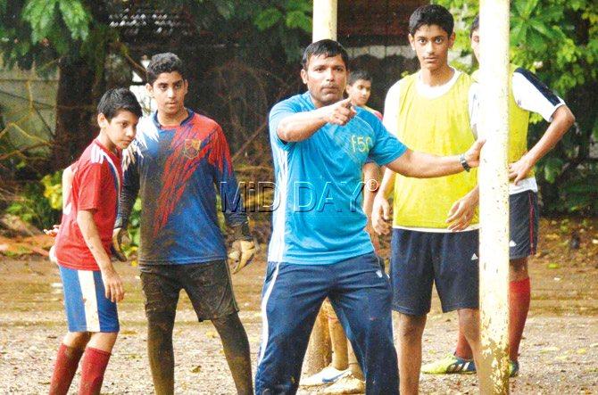 Campion School (Fort) coach Wilfred Alva (blue jersey) instructs his players during a training session near Cooperage ground recently. Pic/Suresh Karkera