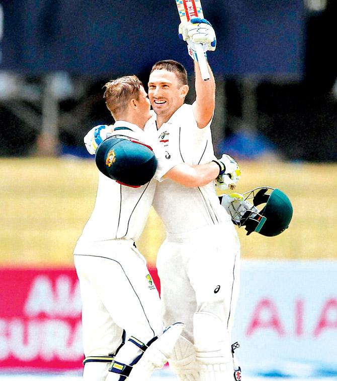 Shaun Marsh (right) celebrates a century as Steve Smith hugs him during the third Test vs SL in Colombo yesterday. Pic/AP,PTI