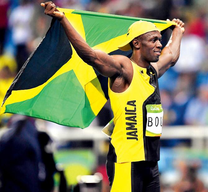 Usain Bolt with the Jamaican flag after winning the 100m final in Rio on Sunday. Pics/Getty Images