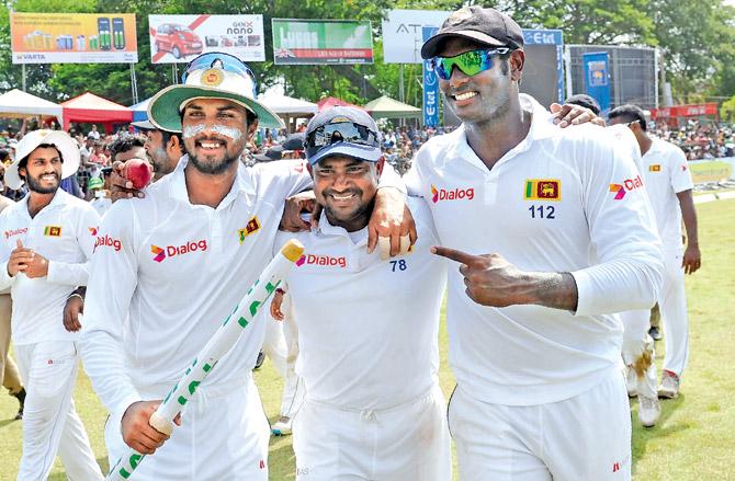 Sri Lanka skipper Angelo Mathews (right) celebrates with teammates Rangana Herath (centre) and Dinesh Chandimal after winning the third and final Test against Australia at Sinhalese Sports Club ground in Colombo yesterday. Pic/AFP
