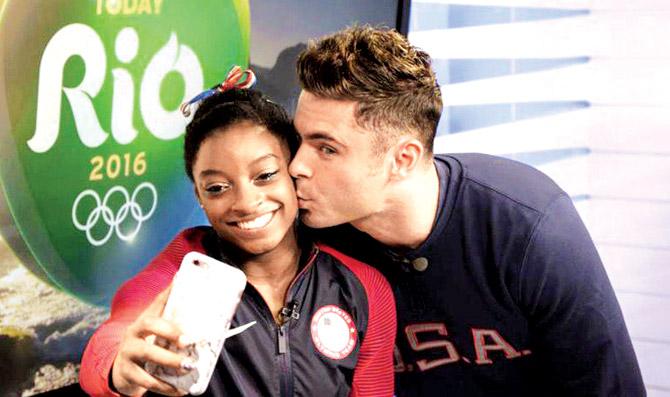 Simone Biles posted this picture on Twitter of Efron kissing her