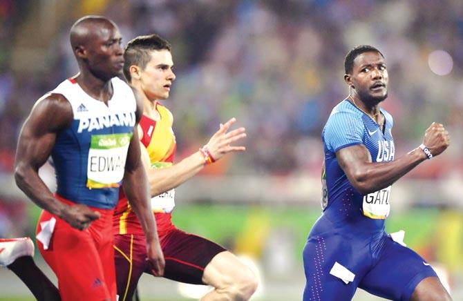 Justin Gatlin (right) competes in the men