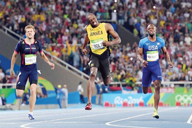 ABOVE: Jamaica’s Usain Bolt (centre) crosses the finish line to win 200m gold.