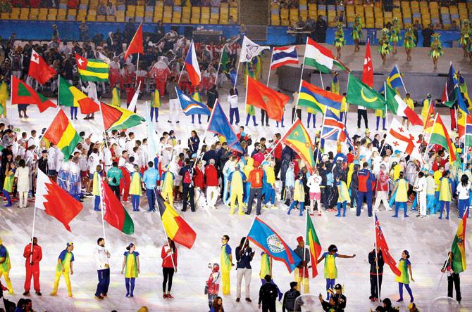 Athletes with their respective national flags during the march past