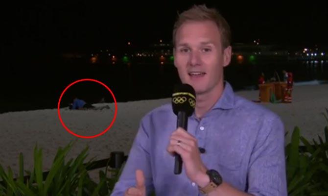 Awkward! Couple caught getting cosy behind presenter Dan Walker on live TV!