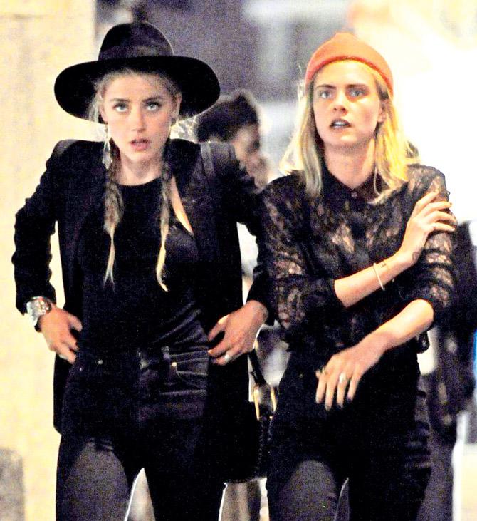 Amber Heard (left) partied with Cara Delevingne