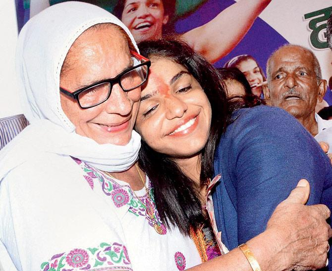 Bronze medal-winning wrestler Sakshi Malik is hugged by her grandmother at Rohtak yesterday.