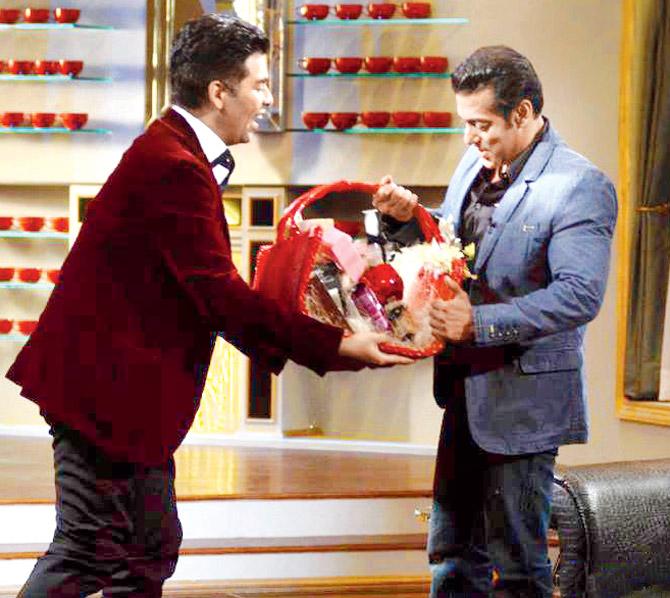 Karan Johar handing the coveted hamper to Salman Khan during the show
