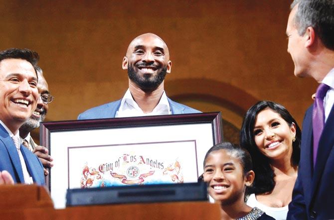 Former LA Laker Kobe Bryant alongwith his family receives a plaque from Los Angeles mayor in California on Wednesday. Pic/AFP