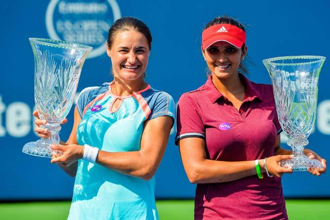 Sania Mirza and Monica Niculescu pose for photos after winning women
