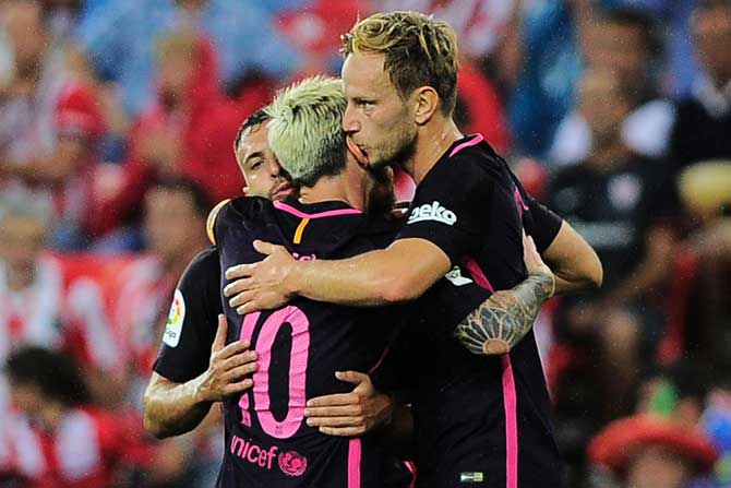 Barcelona midfielder Ivan Rakitic (R) is congratulated by teammates after scoring against Athletic Club Bilbao. Pic /AFP