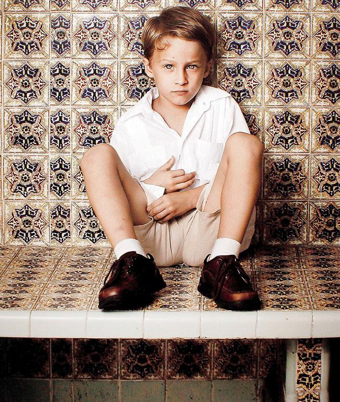 A young boy leans against a Jarocho-style wall. PicâÂu00c2u0080Âu00c2u0088courtesy/Ana D Lombard