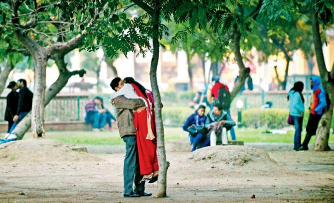 Indian couples enjoying some private time away from the bustle in a park in New Delhi.