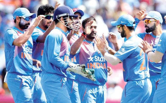 Amit Mishra (third from right) celebrates the fall of WI