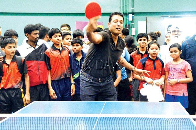 Mahesh Bhupathi tries his hand at table tennis during the launch of the 11EVEN inter-school table tennis championship at Khar Gymkhana yesterday. Pic/Suresh Karkera