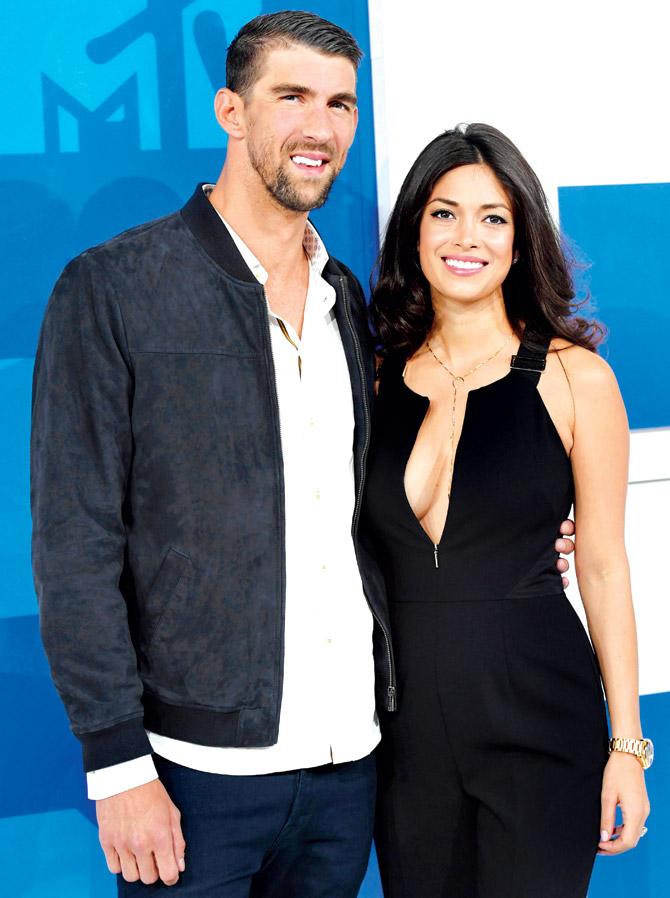 Olympic swimmer Michael Phelps and partner Nicole Johnson. Pic/AFP 