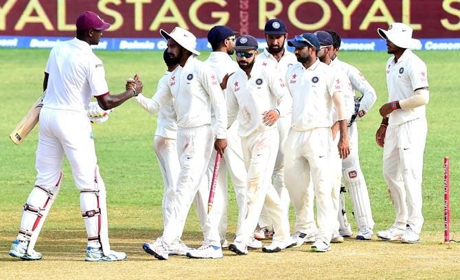 West Indies captain Jason Holder appraoches India players for congratulations at the end of their match on day five of their Second Test cricket match at Sabina Park in Kingston. Pic/AFP