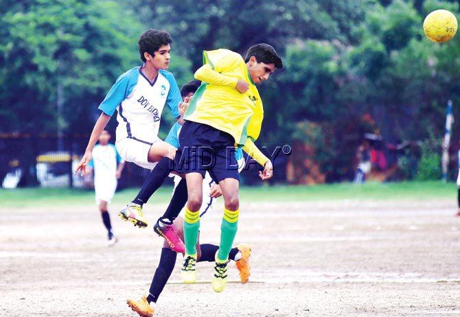 Rajin Mehta of Don Bosco (in white) and Marven Pereira of St Stanislaus (in yellow) in an aerial tussle during their MSSA boys U-16 Division I inter-school football match at Azad Maidan yesterday. Pic/Atul Kamble