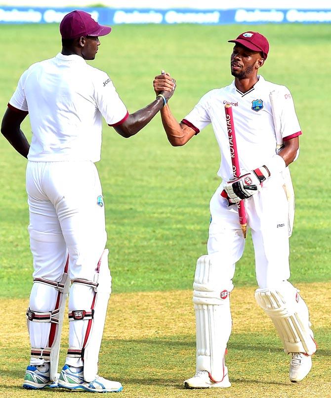 West Indies batsmen Jason Holder (L) and Roston Chase congratulate one another at the end of their match on day five of their Second Test cricket match at Sabina Park in Kingston. Pic/AFP