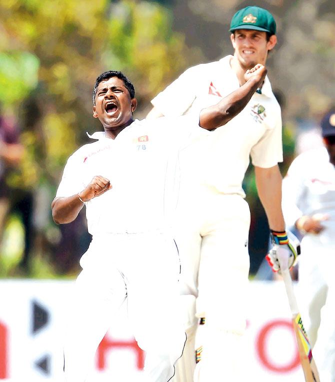 Sri Lankan spinner Rangana Herath celebrates the wicket of Australia