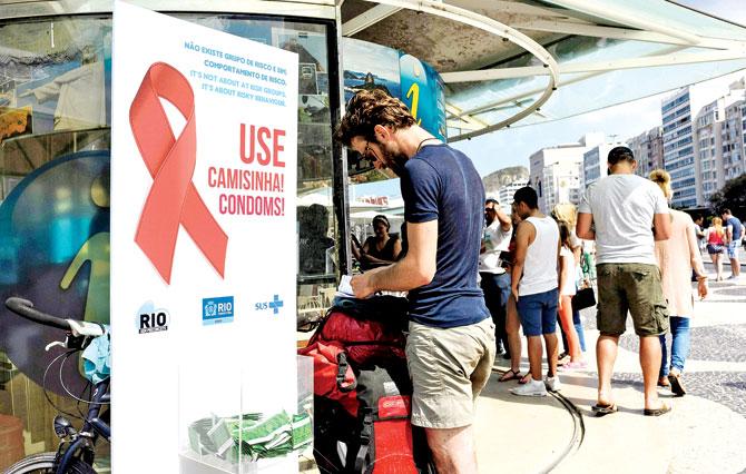 Free condoms are given out to public on Copacabana beach on the eve of Rio Olympic Games opening ceremony yesterday. Pic/AFP