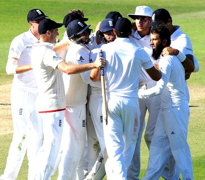 England team celebrate together after Moeen Ali, with beard right, caught and bowled Pakistan