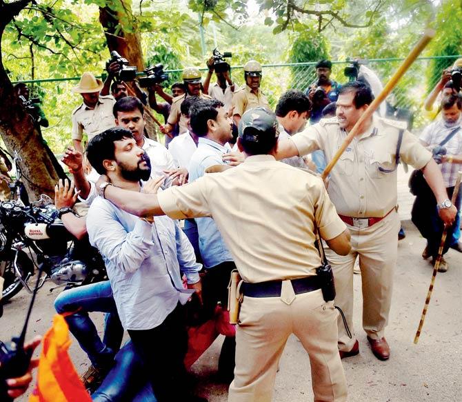 Police baton charge ABVP activists during a protest against the Amnesty International India in Bengaluru. Pic/PTI