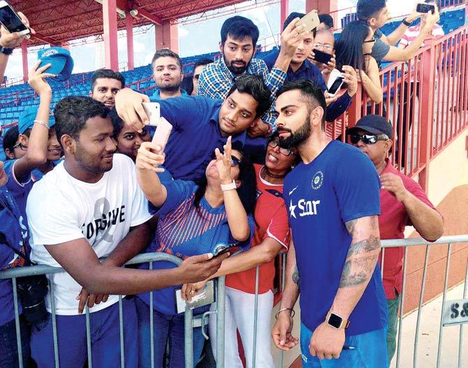 American fans clicking selfies with vice-captain Virat Kohli ahead of team’s training session at Fort Lauderdale in Florida yesterday.