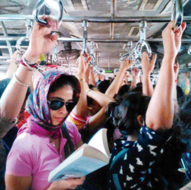 A woman reading a novel in a crowded ladies’ compartment