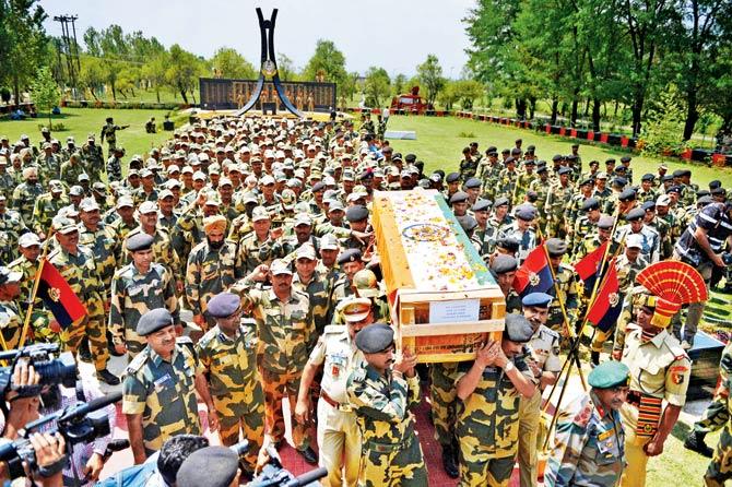 BSF soldiers shout slogans as they carry the coffin of a colleague after a wreath-laying ceremony in Srinagar yesterday. Pic/AFP