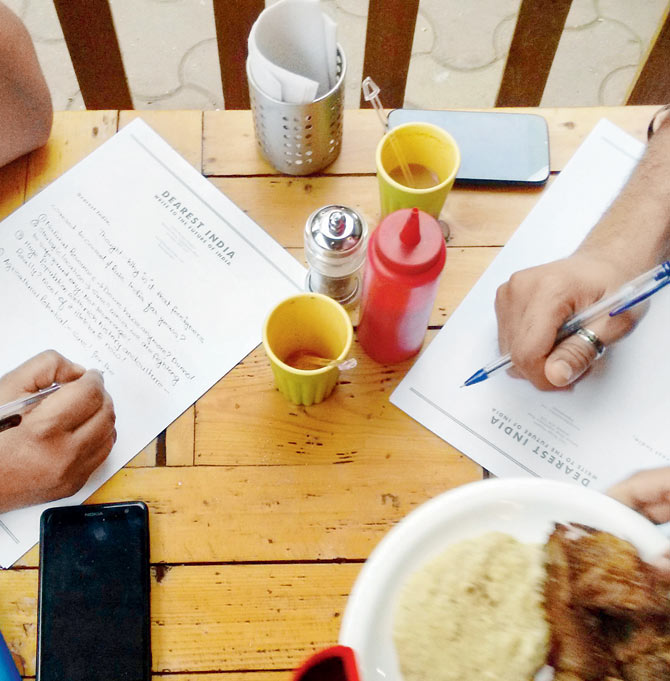 Citizens penning letters at a Dearest India workshop