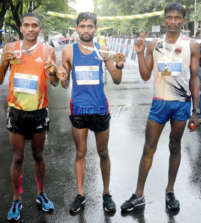 Runner-up Kalidas Hirave (centre) alongwith winner Rahul Kumar Pal (left) and Damor Mohanbhai (right) pose with their medals after the  inaugural IDBI Federal Life Insurance Mumbai Half Marathon at Kala Ghoda yesterday. pic/Bipin Kokate 