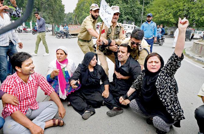 Security forces in Jammu and Kashmir try to pull away National Conference MLAs and MLCs who staged a protest march against civilian killings in Srinagar yesterday. Pic/PTI