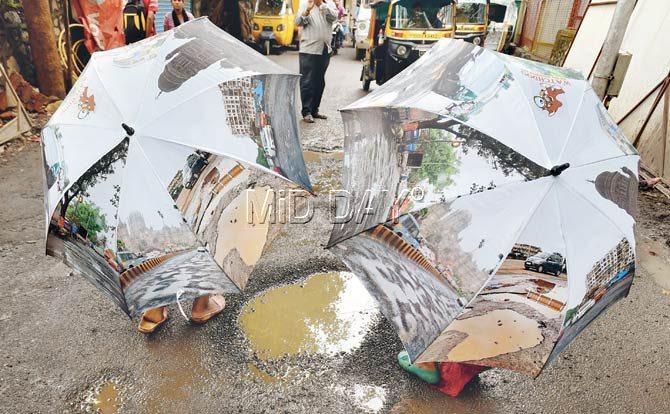 All images on the umbrellas made by an NGO Watchdog and sold to raise funds, ‘celebrate’ the pathetic shape of Mumbai roads. Pic/Rane Ashish