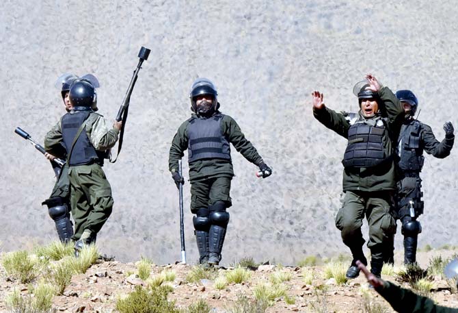 Riot policemen clash with miners in Panduro. Pic/AFP
