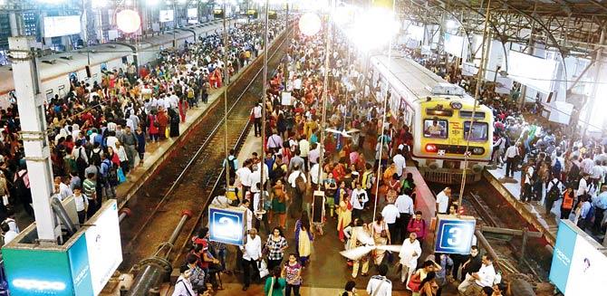 Commuters wait for their trains at Churchgate as services were delayed owing to the fire