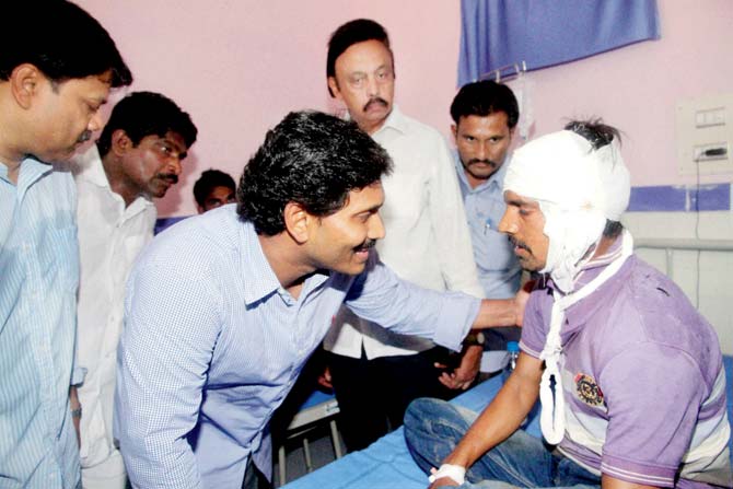 YSR Congress chief Y S Jagan Mohan Reddy meets an injured passenger. Pic/PTI