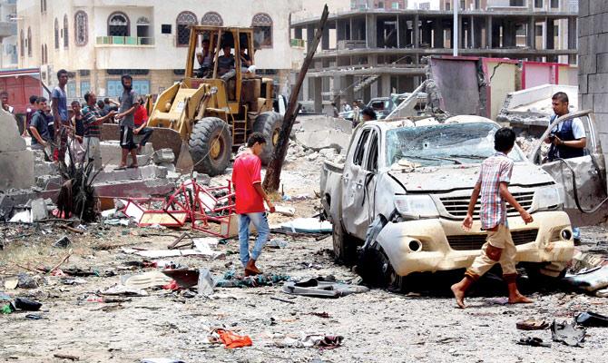 Yemenis inspect the site of the suicide car bombing. Pic/AFP