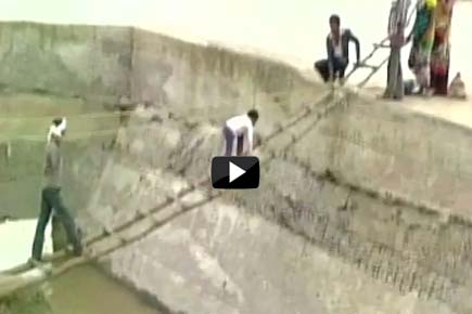Watch Video: People in MP cross overflowing river on makeshift bridge