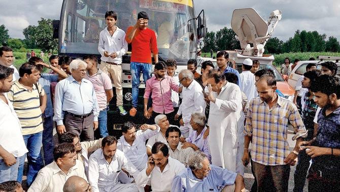 People block NH-91 in Bulandshahr on Sunday to protest the brutal gangrape. PIC/PTI