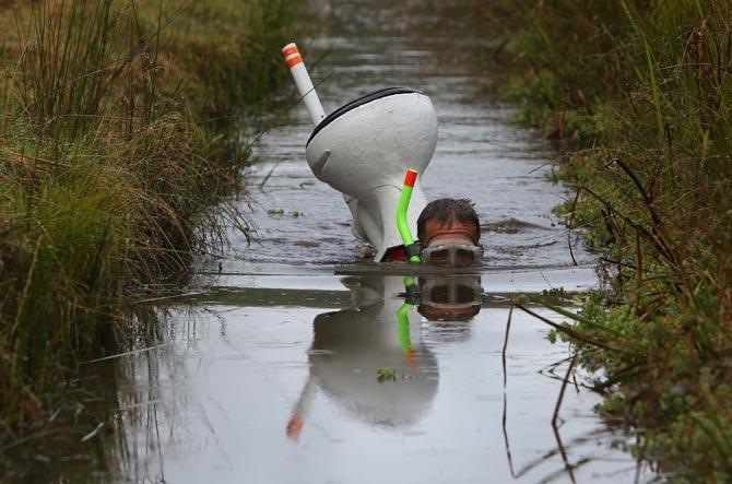 Competitors wearing quirky costumes participated in the World Bog Snorkelling Championships in Waen Rhydd peat bog at Llanwrtyd Wells, south Wales