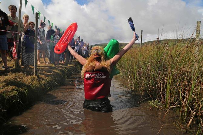 Competitors wearing quirky costumes participated in the World Bog Snorkelling Championships in Waen Rhydd peat bog at Llanwrtyd Wells, south Wales