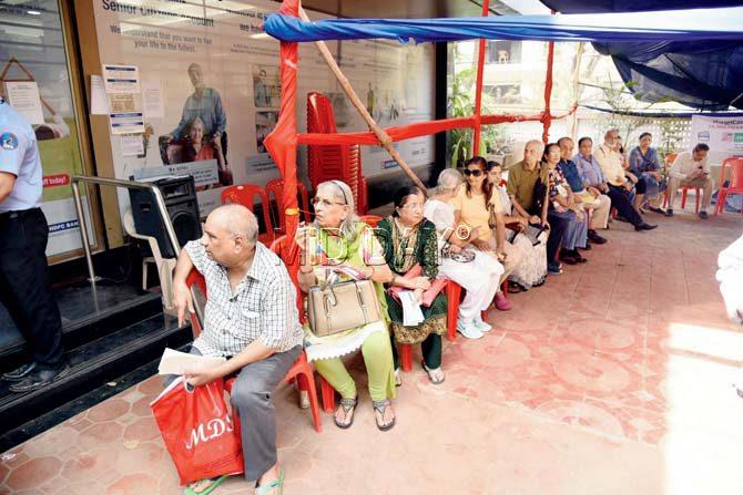 Senior citizens outside an HDFC branch in Versova