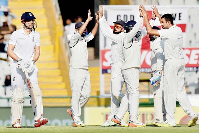 Indian players celebrate the dismissal of England skipper Alastair Cook on Day Three of the third Test in Mohali recently. Pic/PTI 