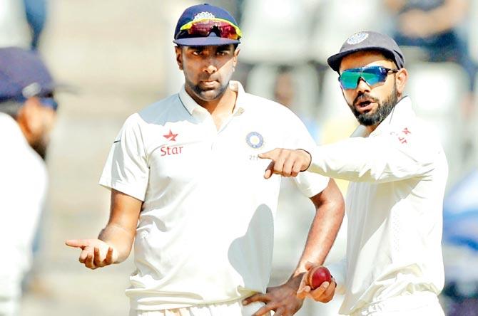India captain Virat Kohli right interacts with off-spinner Ravichandran Ashwin on Day One of the fourth Test against England at the Wankhede Stadium in Mumbai on Thursday. Ashwin has been a terrific performer for India in Test cricket over the last to seasons. Pic/AFP