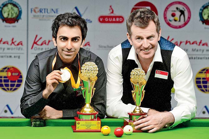 Winner Pankaj Advani (left) and Peter Gilchrist pose with their trophies after the World Billiards final in Bangalore yesterday. pic/PTI